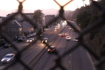 Highway as seen through a chain link fence